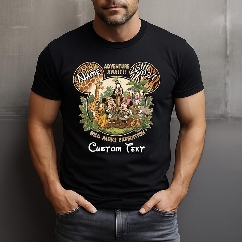 May include: Black t-shirt featuring a Disney-themed design. The design includes Mickey Mouse, Minnie Mouse, Donald Duck, and other characters in safari attire. Text includes "Adventure Awaits!" and "Wild Parks Expedition". The shirt has a customizable name and text area.