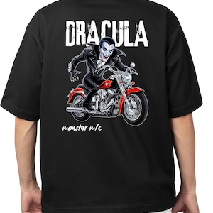May include: Black t-shirt with a white graphic of Dracula riding a motorcycle. The text "Dracula" and "monster m/c" are printed in white on the shirt.