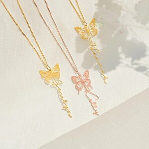 May include: Three gold necklaces with butterfly pendants and personalized names. The names are "Hannah", "Jacqueline", and "Emily".
