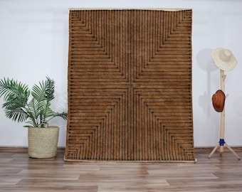 May include: A brown and black geometric patterned rug with a grid design. The rug has a subtle sheen and is made of a soft, plush material.