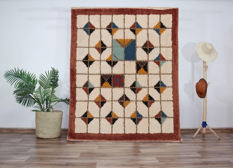 Soft, plush Moroccan Mrirt rug in a creamy wool tone, featuring a unique grid of raised square tiles. The design creates a highly tactile and dimensional surface perfect for contemporary or minimalist interiors. Hand-knotted with precision by Berber artisans, this luxurious rug adds depth, comfort, and understated style to living rooms, bedrooms, or cozy reading corners. A high-end handmade carpet for those who value both texture and design.