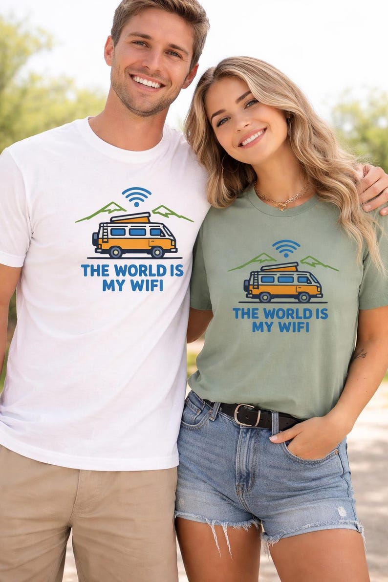 May include: White and sage green t-shirts with a graphic of a yellow camper van, mountains, and a WiFi symbol. The text on the shirts reads "THE WORLD IS MY WIFI". The shirts are worn by two people.