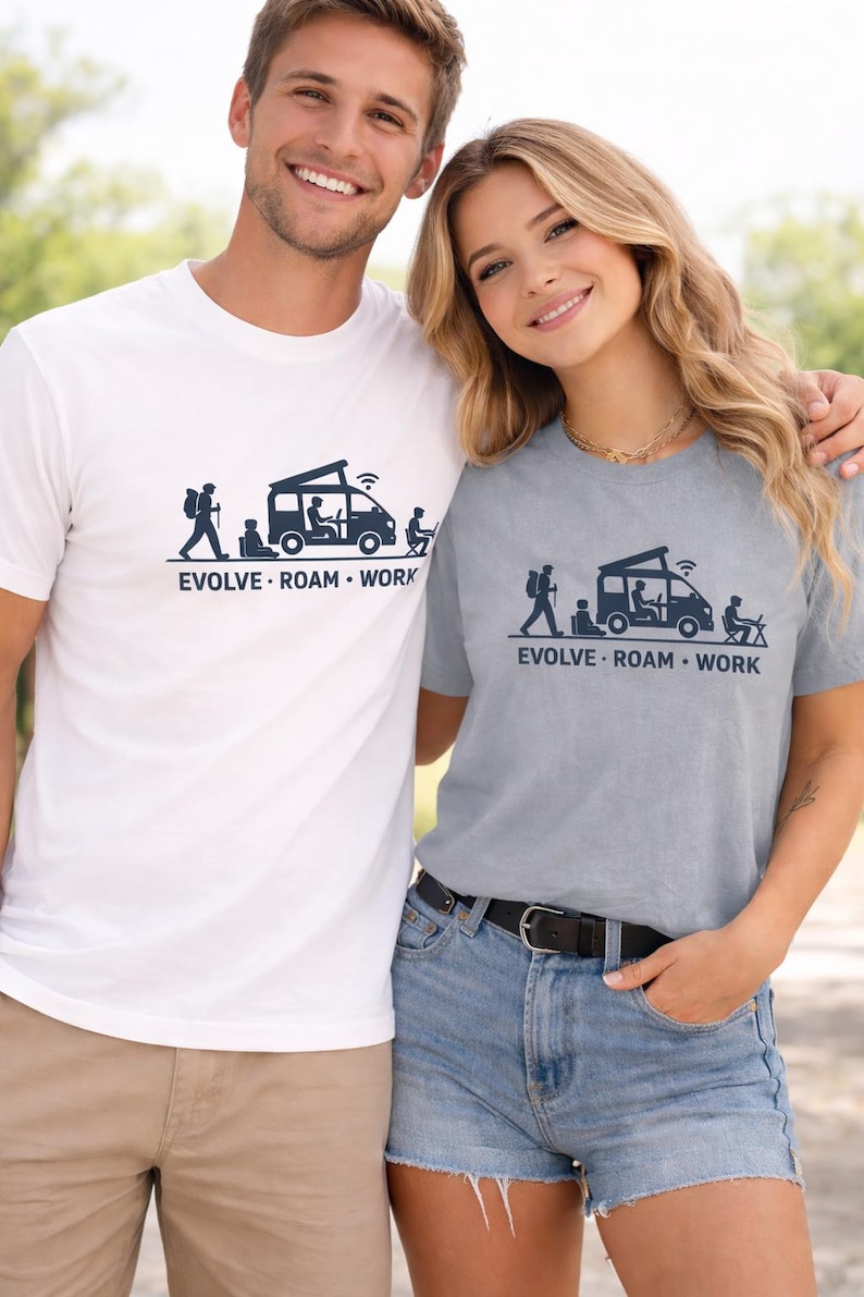 Smiling man and woman outdoors wearing “EVOLVE · ROAM · WORK” graphic t-shirts — man in white, woman in light grey — with a camper van and remote-work silhouettes printed on the front.