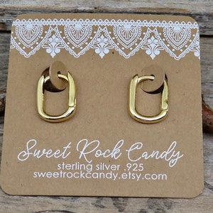 May include: Gold hoop earrings with a square shape. The earrings are on a brown card with the text "Sweet Rock Candy, sterling silver .925, sweetrockcandy.etsy.com".