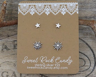 May include: Two pairs of silver stud earrings on a brown display card. The top pair features simple five-pointed stars, while the bottom pair depicts detailed suns with rays. The card displays the text Sweet Rock Candy, sterling silver 925, and sweetrockcandy.etsy.com.