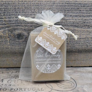 May include: A rectangular brown cardboard box inside a sheer white organza drawstring bag. A square kraft paper tag with white lace-style printing and the text Sweet Rock Candy is attached to the ribbon. A circular white sticker with the text Sweet Rock Candy Unique Artisan Jewelry is on the box.