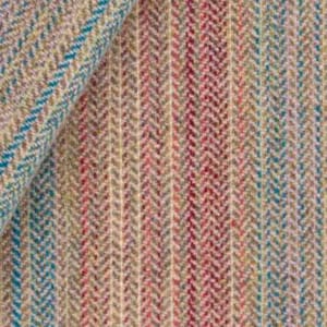 May include: Close-up of a textured fabric with a herringbone pattern. The fabric features vertical stripes in shades of beige, red, and teal. The fabric is folded over, showing the texture and color variations.