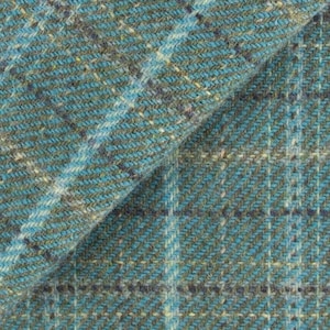 May include: Close-up of a teal and gray tweed fabric with a plaid pattern. The fabric has a textured appearance with a diagonal weave. White and light blue threads create the plaid design. The fabric is folded, showing the texture and color variations.