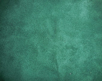 May include: A close-up of a deep green textured fabric surface.