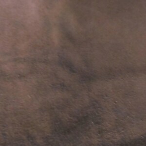 May include: A close-up of a brown textured surface.