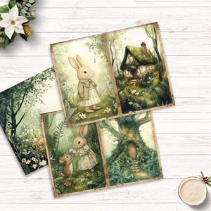 May include: A collection of four rectangular paper prints featuring illustrations of rabbits in clothing, a small cottage with a mossy roof, a tree with a wooden door, and a forest scene with flowers, all rendered in soft green and brown tones.