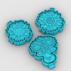 May include: Three blue plastic cookie cutters shaped like sunflowers. The cutters are designed to create cookies with a sunflower design.