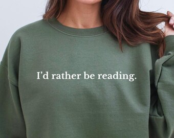 May include: A green sweatshirt with the text "I'd rather be reading." printed in white.