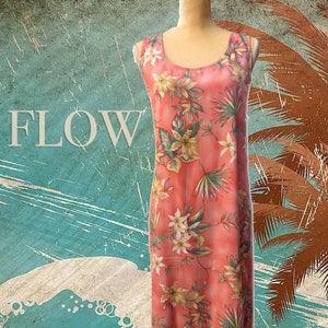May include: A sleeveless, floor-length coral dress with a floral pattern of white, green, and yellow flowers and leaves. The dress has a scoop neckline and is displayed on a mannequin. The word "FLOW" is visible in the background.