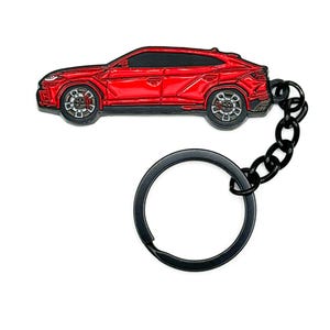 May include: A red car-shaped keychain with black accents. The keychain features a detailed car design with black wheels and a black chain connecting to a black key ring. The car is a vibrant red color.
