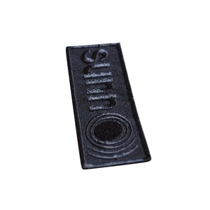 May include: Black embroidered patch with the word "Sun" in a stylised font and a circle design.