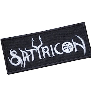 May include: Black embroidered patch with white lettering that reads "SATYRICON" with a white cross symbol.