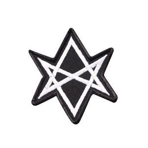 Puede incluir: Un parche bordado en negro y blanco con forma de estrella de seis puntas con un contorno blanco. La estrella tiene un diseño blanco en su interior.