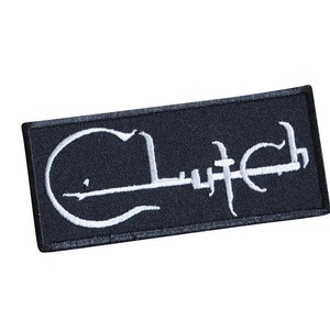 May include: Black embroidered patch with the word "Clutch" in white lettering. The "C" is styled as a guitar.