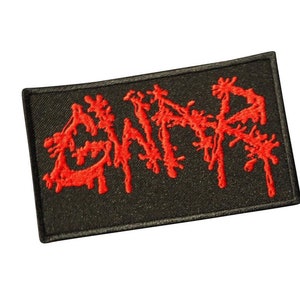 May include: Red embroidered patch with the word "GWAR" in a dripping, stylized font on a black background.