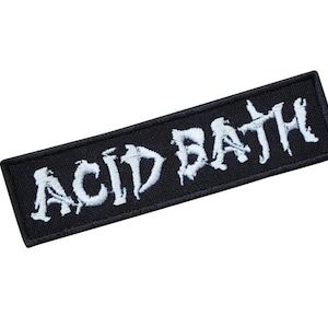 May include: Black embroidered patch with the white text "ACID BATH" in a stylised font.