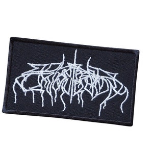May include: A black rectangular patch featuring white embroidered text in a gothic style. The patch has a black border and is designed to be sewn or ironed onto clothing or bags.