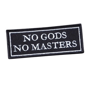 May include: Black embroidered patch with white text that reads "NO GODS NO MASTERS".