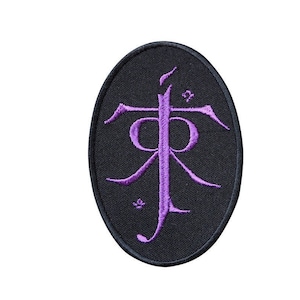 May include: Purple embroidered symbol on a black oval patch. The symbol is a stylised letter "R" with a circle around it.