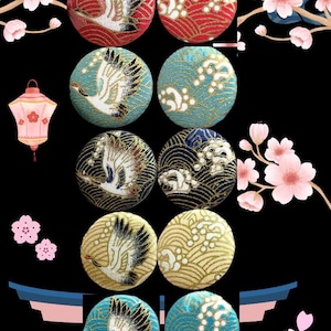 May include: A selection of round fabric buttons with Japanese-inspired designs. Each button features a crane or wave pattern in red, blue, gold, and navy blue. The background is black with cherry blossom and lantern illustrations.
