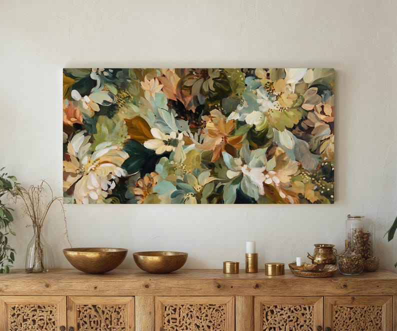 May include: A large floral painting with a mix of colors, including white, green, and peach. The artwork is displayed above a wooden cabinet with gold bowls and decorative items.