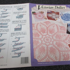May include: A vintage craft pattern book titled "Victorian Doilies" by Needlecraft. The cover features a large pink doily design and smaller images of other doilies. Instructions for crochet stitches are also shown.