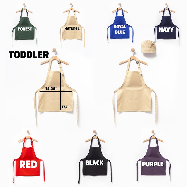 May include: A set of ten toddler-sized aprons in various colors, including forest green, natural, royal blue, navy, red, black, and purple. The aprons are hanging on hangers and have adjustable straps. The aprons are 14.96 inches wide and 17.71 inches long. The set also includes a white chef's hat.