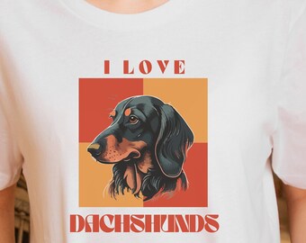 Könnte beinhalten: Weißes T-Shirt mit einer Grafik eines Dackelhundes und dem Text "I LOVE DACHSHUNDS". Die Hundeillustration befindet sich vor einem roten und orangefarbenen Hintergrund.