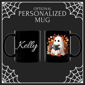 May include: Black ceramic mug with a Halloween theme. One side features the name "Kelly" in white script. The other side has a ghost reading a book, surrounded by pumpkins and fall leaves. The mug is personalized.