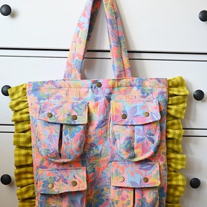 The Big Hen Bag is a fun, funky and functional tote bag featuring 4 cargo pockets, heavy duty snaps, bold brocade outer and cotton lining.