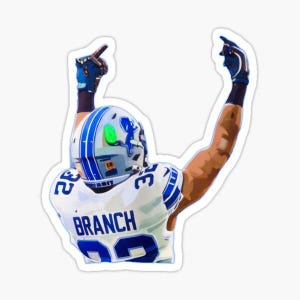 May include: A football player wearing a white and blue jersey with the number 22 and the name "BRANCH" on the back. He is raising both arms in the air, celebrating a touchdown.
