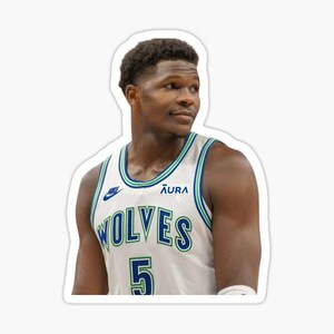 May include: A sticker featuring a basketball player in a white and green jersey. The jersey has the word "WOLVES" in green and the number "5" in green. The Nike logo is visible on the jersey.