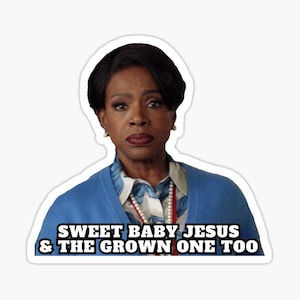 May include: A sticker featuring a woman with dark hair and a serious expression. She is wearing a blue sweater over a patterned blouse and a pearl necklace. The text "SWEET BABY JESUS & THE GROWN ONE TOO" is below her.