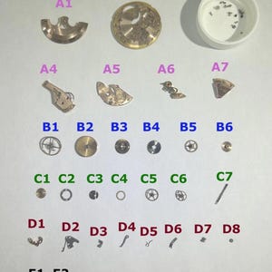 Piezas de reloj Omega 551 Movimiento Balance Horquilla Ruedas Resortes Puente 550 565 750