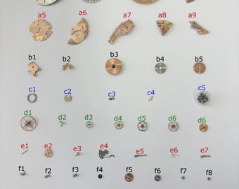 Peças do mecanismo do relógio Omega Cal 564: disco do calendário, garfo, rodas, molas, ponte.