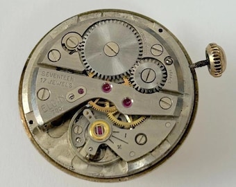 Mechanizm zegarka Elgin Cal 720 do części, mostka sprężynowego i balansu
