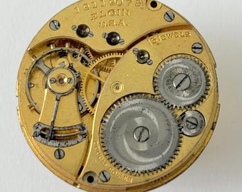 Relógio de bolso Elgin Grade 377 com movimento parcial, garfo de equilíbrio, mola e ponte