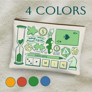 May include: A white canvas zippered pouch with a green, yellow, and blue design featuring various game-related illustrations, including dice, playing cards, a chess piece, and the words "play more games together".