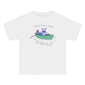 May include: White t-shirt featuring a cartoon illustration of a bear in a boat, fishing. The bear is purple, and the boat is green. Text on the shirt reads "Ripple in Still Water" and "When there is no pebble tossed nor wind to blow."