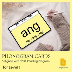 May include: A digital tablet displaying a phonogram card with the text 'ang', 'ang sang /ăng/', and 'wh whisk /hw/'. The screen is yellow with black text. A white stylus is positioned near the screen, which is held over a soft white fabric.