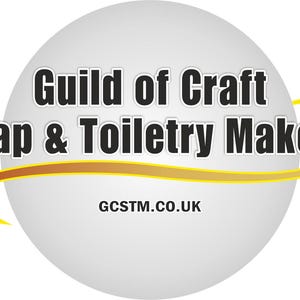 May include: A logo for the Guild of Craft Soap &amp; Toiletry Makers, with text in a white and black design on a grey sphere. A yellow and orange curved line accents the sphere. The website address is also included.