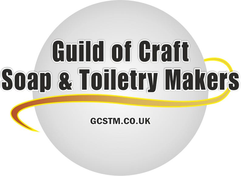 May include: A logo for the Guild of Craft Soap &amp; Toiletry Makers, with text in a white and black design on a grey sphere. A yellow and orange curved line accents the sphere. The website address is also included.