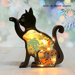 May include: A black wooden cat silhouette with a light-up scene inside. The scene features a sunset, palm trees, and a house. The cat is sitting on a white surface. "Cat-A With Light" is written in the top right corner of the image.