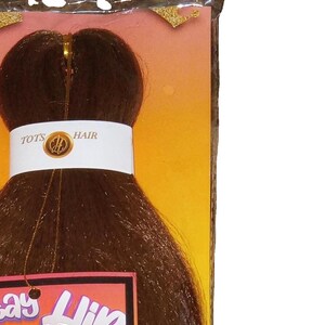 May include: A package of Stay Hip children's braiding hair in the color Honey. The package features a cartoon girl with a crown and the text "Stay Hip" and "Prize Inside".