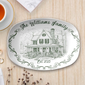 May include: Oval ceramic platter with a green and white illustration of a house and the text "The Williams Family Est. 2025". The platter has a decorative green border and is on a light wood surface.